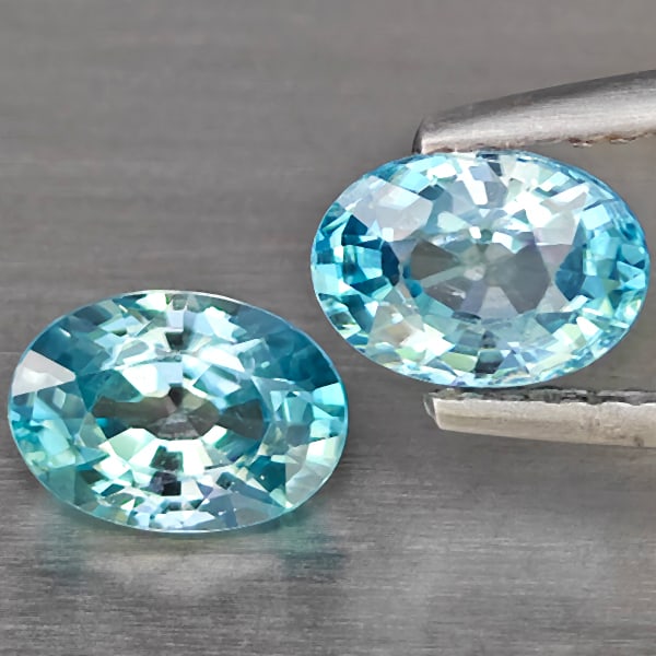 Natural Blue Zircon 2.45 Ct. 2 Pcs Oval Shape 7.1 x 5.2 Mm Gemstone From Cambodia: Product ID: 807725459 Product Name: Natural Zircon Weight: 2.45 CT. Size: 7.1 x 5.2 x 3.6 MM. Shape: Oval Shape Color: Blue Clarity:SI1 Luster: Good Gems Origin: Cambodia Treatment: Heated Crystal Str