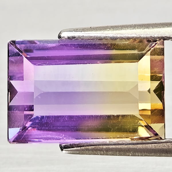 Natural Bi Color Ametrine 2.88 Ct. Baguette Shape 10.2 x 6.7 Mm Gemstone From Bolivia: Product ID: 800408267 Product Name: Natural Ametrine Weight: 2.88 CT. Size: 10.2 x 6.7 x 5.2 MM. Shape: Baguette Color: Bi Color Clarity:VSI Luster: Good Gems Origin: Bolivia Treatment: Unheated Cryst