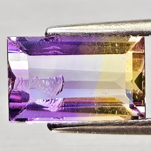 Natural Bi Color Ametrine 2.04 Ct. Baguette Shape 9.6 x 6 Mm Gemstone From Bolivia: Product ID: 800408259 Product Name: Natural Ametrine Weight: 2.04 CT. Size: 9.6 x 6 x 4.4 MM. Shape: Baguette Color: Bi Color Clarity:VSI - SI1 Luster: Good Gems Origin: Bolivia Treatment: Unheated Cr