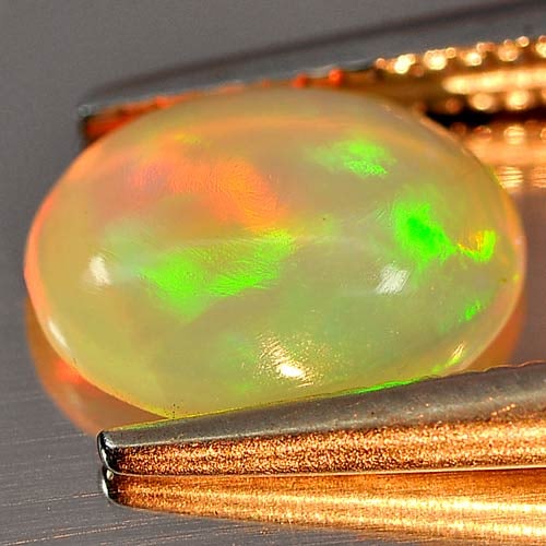 Natural Multi Color Opal 0.66 Ct. Oval Cabochon Shape 8.1 x 6.2 Mm. Unheated Gemstone: Product ID: 818726369 Product Name: Natural Opal Weight: 0.66 CT. Size: 8.1 x 6.2 x 3 MM. Shape: Oval Cabochon Color: Multi Color Clarity:Semi - Transparent Luster: Iridescent Gems Origin: Ethiopia Tr