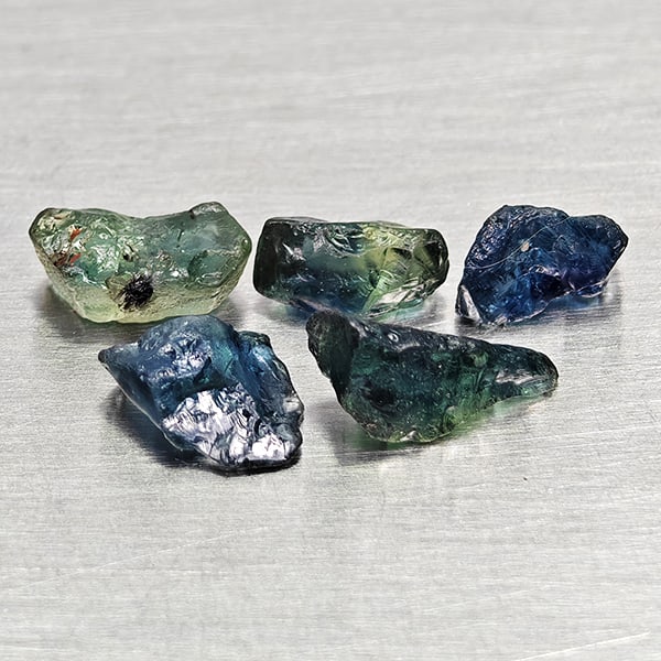 Natural Greenish Blue Sapphire 2.26 Ct. 5 Pcs Rough Shape Gemstones From Madagascar: Product ID: 806162540 Product Name: Natural Green Sapphire Weight: 2.26 CT. Size: 5.4 x 2.7 x 2.7 to 7.4 x 3.2 x 2.8 MM. Shape: Rough Mixed Shape Color: Greenish Blue Clarity:VSI Luster: Good Gems Ori