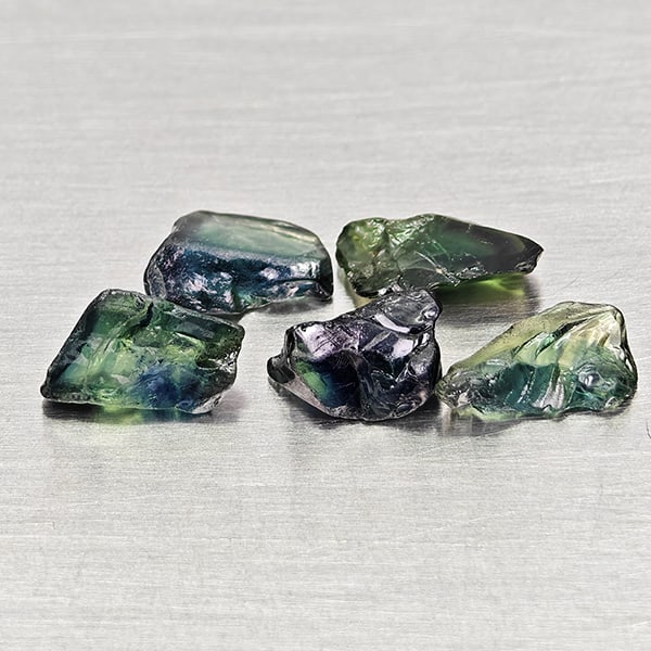 Natural Greenish Blue Sapphire 3.93 Ct. 5 Pcs Rough Shape Gemstones from Madagascar: Product ID: 806162529 Product Name: Natural Green Sapphire Weight: 3.93 CT. Size: 6.6 x 5 x 4.4 to 8.1 x 5.4 x 2.2 MM. Shape: Rough Mixed Shape Color: Greenish Blue Clarity:VSI Luster: Good Gems Origi