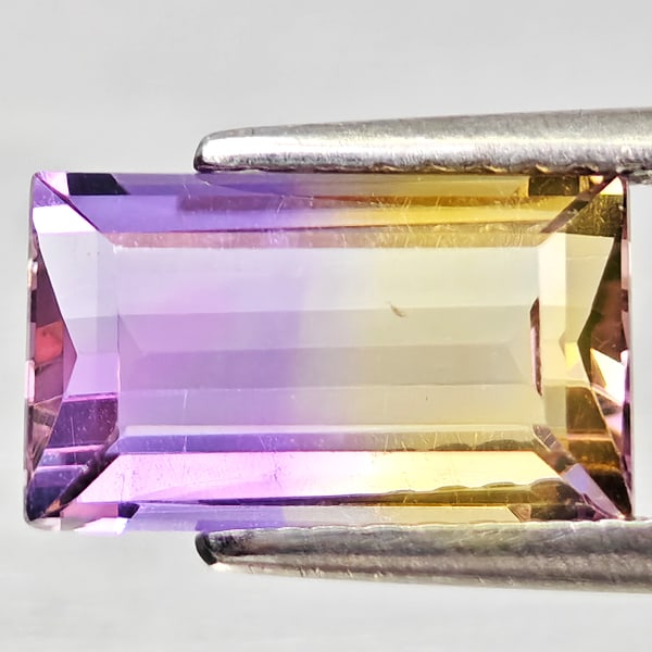 Natural Bi Color Ametrine 2.17 Ct. Octagon Shape 10.4 x 6.2 Mm Gemstone from Bolivia: Product ID: 800408409 Product Name: Natural Ametrine Weight: 2.17 CT. Size: 10.4 x 6.2 x 4.2 MM. Shape: Octagon Color: Bi Color Clarity:VSI - SI1 Luster: Good Gems Origin: Bolivia Treatment: Unheated