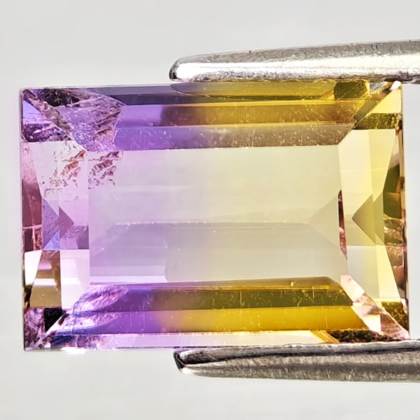 Natural Bi Color Ametrine 2.84 Ct. Baguette Shape 10.2 x 7.1 Mm. Gemstone From Bolivia: Product ID: 800408252 Product Name: Natural Ametrine Weight: 2.84 CT. Size: 10.2 x 7.1 x 4.9 MM. Shape: Baguette Color: Bi Color Clarity:VSI Luster: Good Gems Origin: Bolivia Treatment: Unheated Cryst