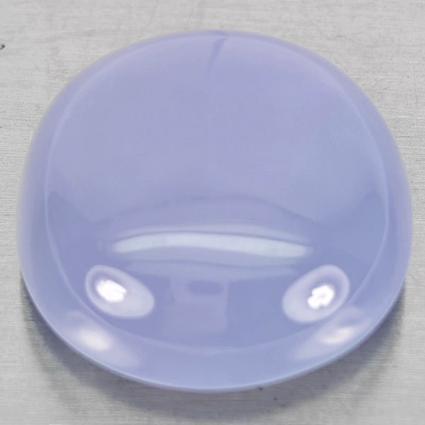 Natural Lavender Chalcedony 27.38 Ct. Cushion Cabochon Shape 20 x 19 Mm. Gemstone: Product ID: 801502662 Product Name: Natural Chalcedony Weight: 27.38 CT. Size: 20 x 19 x 9.3 MM. Shape: Cushion Cabochon Color: Lavender Clarity:Semi - Transparent Luster: Good Gems Origin: Russia Tre