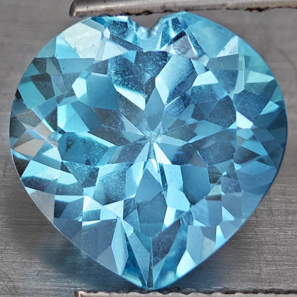 Natural Baby Blue Topaz 5.42 Ct. Heart Shape 11.2 Mm Gemstone From Brazil: Product ID: 807168729 Product Name: Natural Blue Topaz Weight: 5.42 CT. Size: 11.2 x 11.2 x 6.9 MM. Shape: Heart Shape Color: Baby Blue Clarity:VSI Luster: Good Gems Origin: Brazil Treatment: Treated