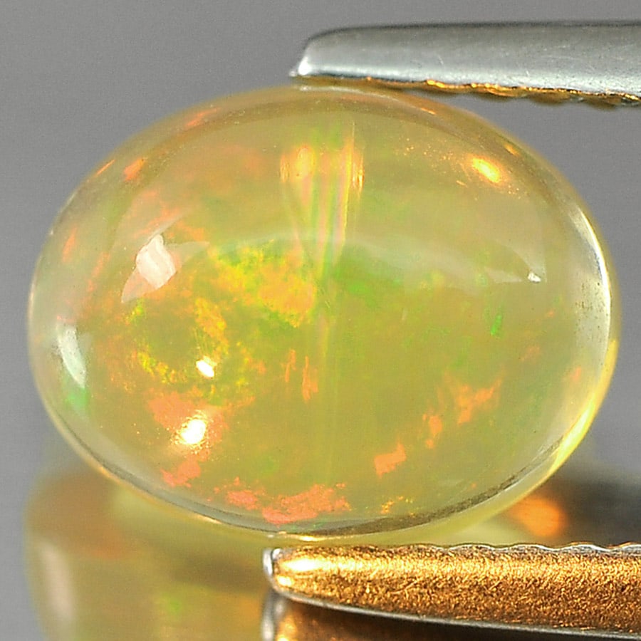 Natural Multi Color Opal 1.40 Ct. Oval Cabochon Shape 9.1 x 7.1 Mm Gemstone from Ethiopia: Product ID: 818727064 Product Name: Natural Opal Weight: 1.40 CT. Size: 9.1 x 7.1 x 4.5 MM. Shape: Oval Cabochon Color: Multi-Color Clarity:Semi - Transparent Luster: Iridescent Gems Origin: Ethiopia
