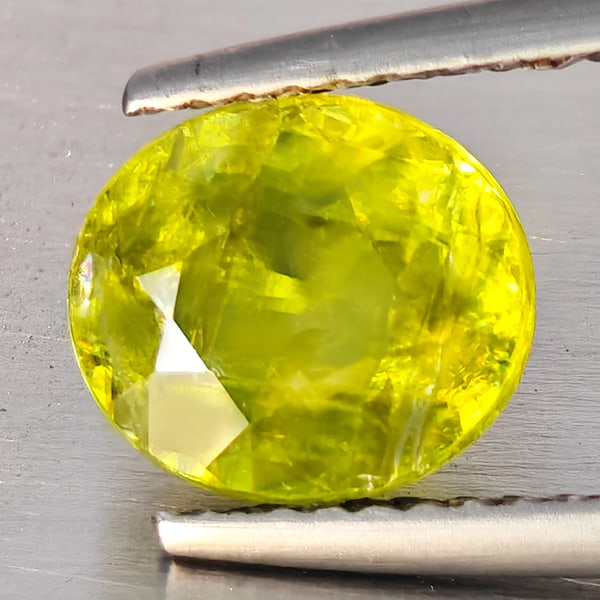 Natural Intense Green Titanium With Rainbow Spark Sphene 1.89 Ct. Oval Shape 8.2 x 7.2 Mm Gemstone: Product ID: 806509146 Product Name: Natural Sphene Weight: 1.89 CT. Size: 8.2 x 7.2 x 4 MM. Shape: Oval Color: Intense Green Titanium With Rainbow Spark Clarity:SI1 Luster: Good Gems Origin: Madagasca