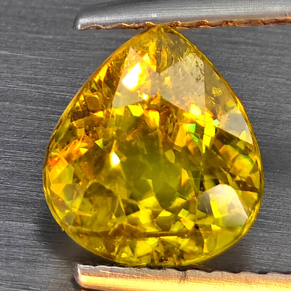 Natural Multi-Color With Rainbow Spark Sphene 1.62 Ct. Pear Shape 7.9 x 7.2 Mm Gemstone From: Product ID: 806509095 Product Name: Natural Sphene Weight: 1.62 CT. Size: 7.9 x 7.2 x 4.6 MM. Shape: Pear Shape Color: Multi-Color Clarity:SI1 Luster: Good Gems Origin: Madagascar Treatment: Unheated