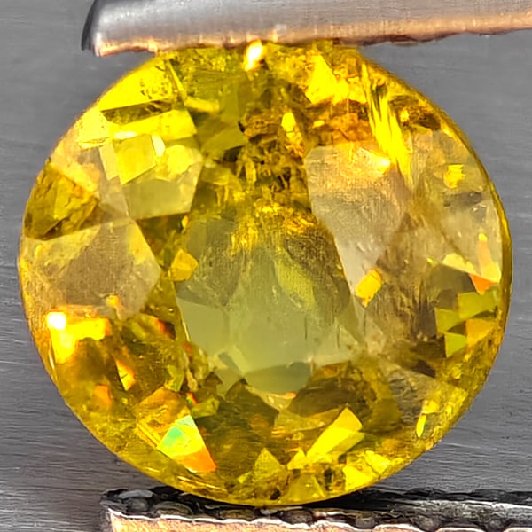 Natural Multi-Color With Rainbow Spark Sphene 1.37 Ct. Round Shape 6.8 Mm Gemstone From Madagascar: Product ID: 806509098 Product Name: Natural Sphene Weight: 1.37 CT. Size: 6.8 x 6.8 x 4.4 MM. Shape: Round Shape Color: Multi-Color Clarity:SI1 Luster: Good Gems Origin: Madagascar Treatment: Unheated