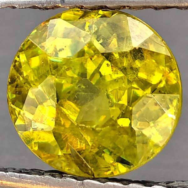 Natural Multi-Color Sphene With Rainbow Spark 1.67 Ct. Round Shape 6.7 Mm. Gemstone From Madagascar: Product ID: 806509099 Product Name: Natural Sphene Weight: 1.67 CT. Size: 6.7 x 6.7 x 4.9 MM. Shape: Round Shape Color: Multi-Color Clarity:SI1 Luster: Good Gems Origin: Madagascar Treatment: Unheated