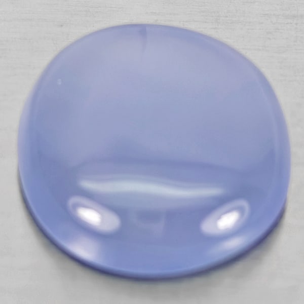 Natural Lavender Chalcedony 26.44 Ct. Oval Cabochon Shape 22 x 20 Mm. Unheated Gemstone: Product ID: 801502701 Product Name: Natural Chalcedony Weight: 26.44 CT. Size: 22 x 20 x 9.5 MM. Shape: Oval Cabochon Color: Lavender Clarity:Semi - Transparent Luster: Good Gems Origin: Russia Treatm