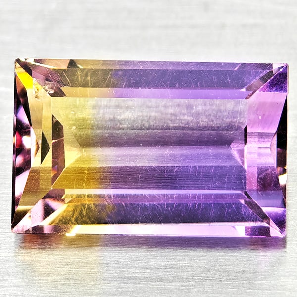 Natural Bi Color Ametrine 3.42 Ct. Baguette Shape 11.4 x 7.3 Mm Gemstone From Bolivia: Product ID: 800408515 Product Name: Natural Ametrine Weight: 3.42 CT. Size: 11.4 x 7.3 x 5.2 MM. Shape: Baguette Color: Bi Color Clarity:VSI Luster: Good Gems Origin: Bolivia Treatment: Unheated Cryst