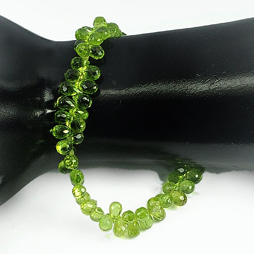 Natural Green Peridot 91.30 Ct. Beads Length 9 Inch Gemstone from Thailand: Product ID: 805306803 Product Name: Natural Peridot Weight: 91.30 CT. Size: 9 Inch. / 6.3 x 4.3 MM. Shape: Briolette Color: Green Clarity:VVS Luster: Good Gems Origin: Thailand Treatment: Unheated Cry