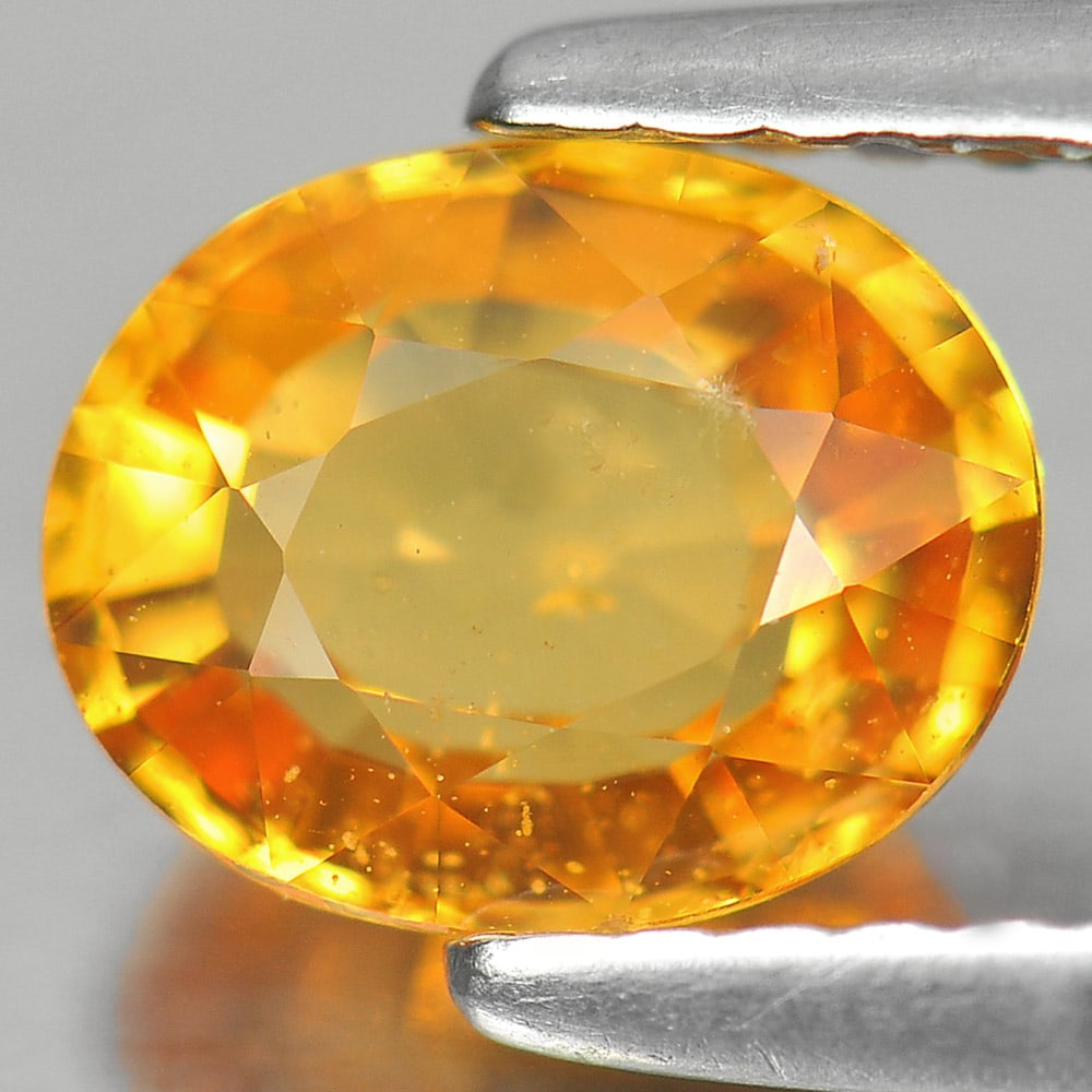 Natural Orange Yellow Sapphire 1.40 Ct. Oval Shape 7.3 x 5.9 Mm. Gemstone from Thailand: Product ID: 806140000 Product Name: Natural Yellow Sapphire Weight: 1.40 CT. Size: 7.3 x 5.9 x 3.4 MM. Shape: Oval Color: Orange Yellow Clarity:SI Luster: Good Gems Origin: Thailand Treatment: Heated