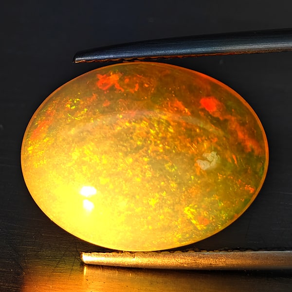 Natural Multi Color Opal 6.30 Ct. Oval Cabochon Shape 16.3 x 12.5 Mm Gemstone from Ethiopia: Product ID: 708700100 Product Name: Natural Opal Weight: 6.30 CT. Size: 16.3 x 12.5 x 6.6 MM. Shape: Oval Cabochon Color: Multi-Color Clarity:Semi - Transparent Luster: Iridescent Gems Origin: Ethiopi