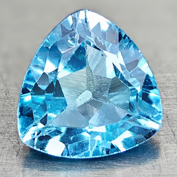 Natural Swiss Blue Topaz 3.30 Ct. Trilliant Shape 9.1 Mm Gemstone From Brazil: Product ID: 807167864 Product Name: Natural Blue Topaz Weight: 3.30 CT. Size: 9.1 x 9.1 x 5.3 MM. Shape: Trilliant Color: Swiss Blue Clarity:VSI Luster: Good Gems Origin: Brazil Treatment: Treated Cry