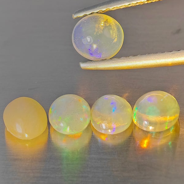 Natural Multi Color Opal 1.82 Ct. 5 Pcs Oval Cabochon Shape 5.3 x 5 Mm Gemstones From Ethiopia: Product ID: 818728425 Product Name: Natural Opal Weight: 1.82 CT. Size: 5.3 x 5 x 2.6 MM. Shape: Oval Cabochon Color: Multi-Color Clarity:Semi - Transparent Luster: Good Gems Origin: Ethiopia Treatmen