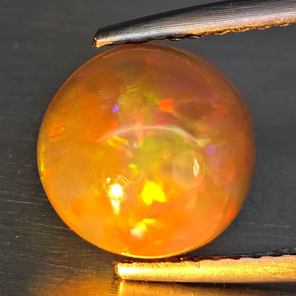 Natural Multi Color Opal 1.78 Ct. Round Cabochon Shape 9.3 Mm Gemstone from Ethiopia: Product ID: 708700038 Product Name: Natural Opal Weight: 2.39 CT. Size: 11.5 x 9.5 x 4.9 MM. Shape: Round Cabochon Color: Multi-Color Clarity:Semi - Transparent Luster: Iridescent Gems Origin: Ethiopi