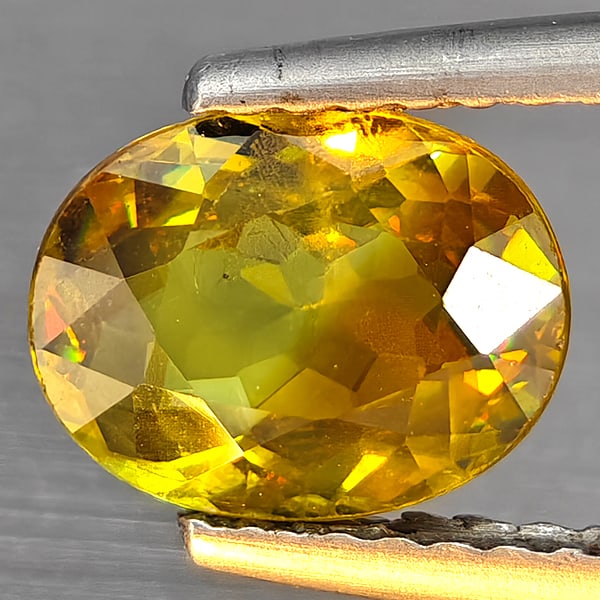 Natural Multi-Color Sphene With Rainbow Spark 1.39 Ct. Oval Shape 8.1 x 6.3 Mm Gemstone from: Product ID: 806509117 Product Name: Natural Sphene Weight: 1.39 CT. Size: 8.1 x 6.3 x 3.4 MM. Shape: Oval Shape Color: Multi-Color Clarity:SI1 Luster: Good Gems Origin: Madagascar Treatment: Unheated 