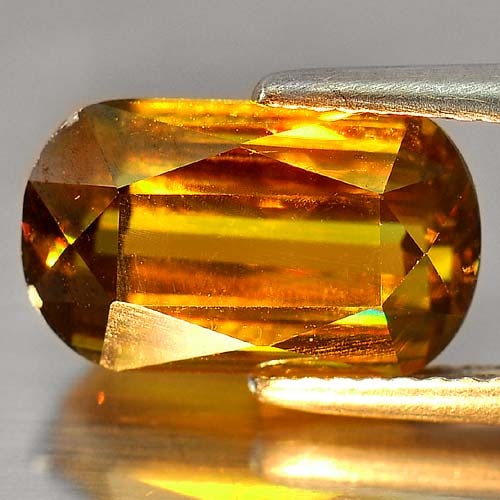 Natural Multi Color Titanium Red Spark Sphene 4.33 Ct. VVS Fancy Shape 12.3 x 7.3 Mm. Gemstone from: Product ID: 806504678 Product Name: Natural Sphene Weight: 4.33 CT. Size: 12.3 x 7.3 x 5.1 MM. Shape: Fancy Color: Multi Color With Red Spark Clarity:VVS Luster: Adamantine Gems Origin: Madagascar Tre