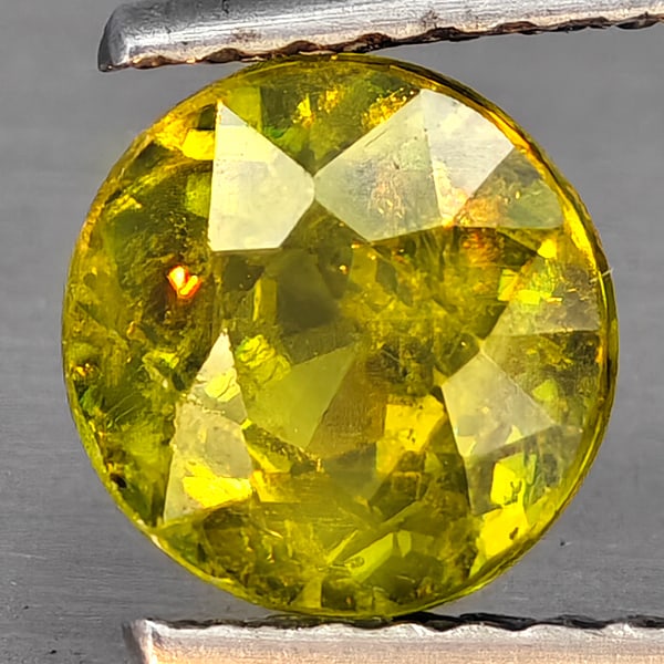 Natural Multi-Color With Rainbow Spark Sphene 1.52 Ct. Round Shape 6.7 Mm Gemstone From Madagascar: Product ID: 806509121 Product Name: Natural Sphene Weight: 1.52 CT. Size: 6.7 x 6.7 x 4.7 MM. Shape: Round Shape Color: Multi-Color Clarity:SI1 Luster: Good Gems Origin: Madagascar Treatment: Unheated