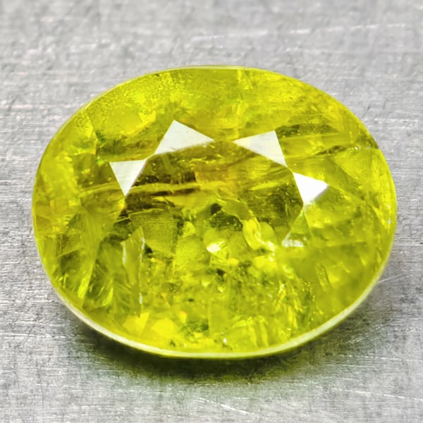 Natural Intense Yellow Green Titanium Red Spark Sphene Gemstones 0.83 Ct. Oval Shape: Product ID: 806509021 Product Name: Natural Sphene Weight: 0.83 CT. Size: 2.3 x 5 x 3.3 MM. Shape: Oval Shape Color: Intense Yellow Green With Red Spark Clarity:SI1 Luster: Good Gems Origin: Madagasca