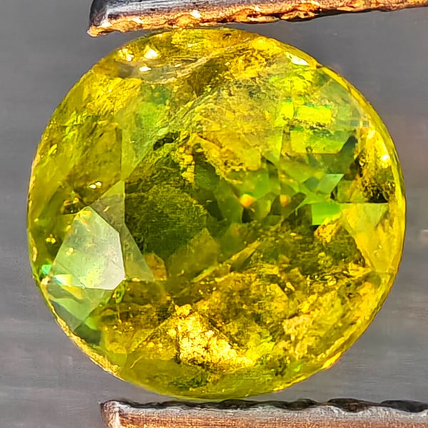 Natural Multi-Color With Rainbow Spark Sphene Gemstones 0.82 Ct. Round Shape 5.8 Mm.: Product ID: 806509252 Product Name: Natural Sphene Weight: 0.82 CT. Size: 5.8 x 5.8 x 3.6 MM. Shape: Round Shape Color: Multi-Color Clarity:SI1 Luster: Good Gems Origin: Madagascar Treatment: Unheated