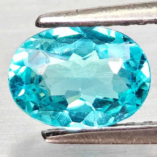 Natural Paraiba Color Apatite Gemstones 0.86 Ct. Oval Shape 7.1 x 5.2 Mm.: Product ID: 800613681 Product Name: Natural Apatite Weight: 0.86 CT. Size: 7.1 x 5.2 x 3.2 MM. Shape: Oval Color: Neon Blue Clarity:VSI Luster: Good Gems Origin: Tanzania Treatment: Unheated Crystal S
