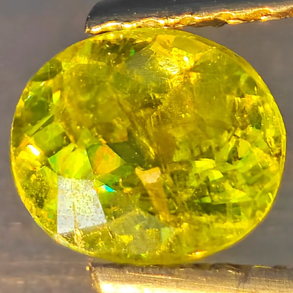 Natural Multi-Color With Rainbow Spark Sphene Gemstones 0.98 Ct. Oval Shape 6.4 x 5.5 Mm.: Product ID: 806509207 Product Name: Natural Sphene Weight: 0.98 CT. Size: 6.4 x 5.5 x 4 MM. Shape: Oval Shape Color: Multi-Color Clarity:SI1 Luster: Good Gems Origin: Madagascar Treatment: Unheated Cr
