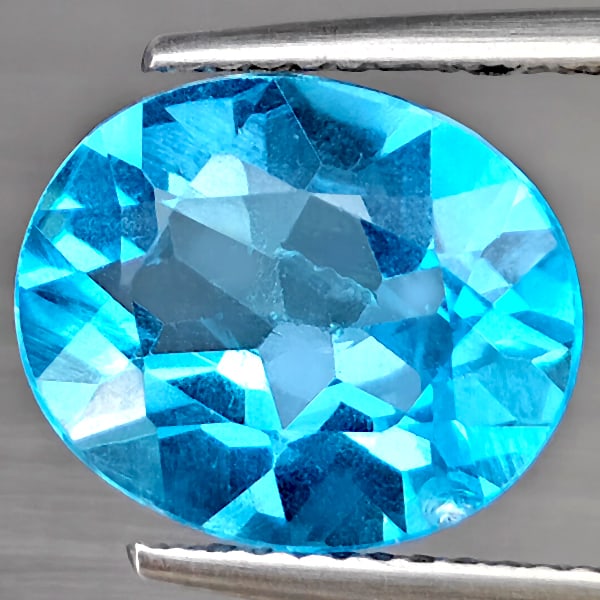 Natural Swiss Blue Topaz Gemstones 4.78 Ct. Oval Shape 12.2 x 10 Mm.: Product ID: 807169022 Product Name: Natural Blue Topaz Weight: 4.78 CT. Size: 12.2 x 10 x 5.6 MM. Shape: Oval Shape Color: Swiss Blue Clarity:VSI Luster: Good Gems Origin: Brazil Treatment: Treated Cr
