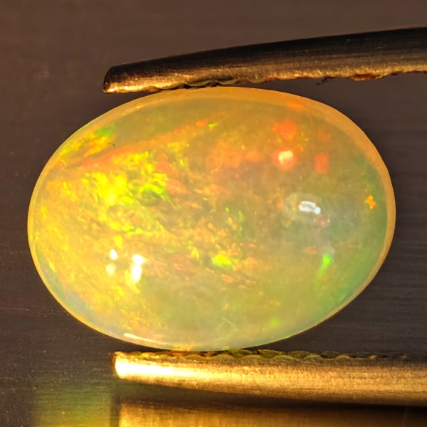 Natural Multi-Color Play Of Colour Opal Gemstones 1.94 Ct. Oval Cabochon Shape 10.4 x 7.5 Mm.: Product ID: 708700161 Product Name: Natural Opal Weight: 1.94 CT. Size: 10.4 x 7.5 x 5.1 MM. Shape: Oval Cabochon Color: Multi-Color Clarity:Opaque Luster: Good Gems Origin: Ethiopia Treatment: Unheat