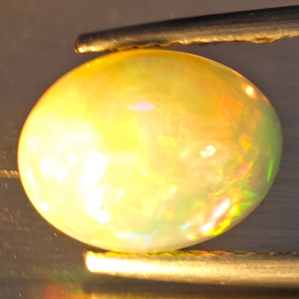Natural Multi-Color Play Of Colour Opal Gemstones 1.83 Ct. Oval Cabochon Shape 10.5 x 8.1 Mm.: Product ID: 708700132 Product Name: Natural Opal Weight: 1.83 CT. Size: 10.5 x 8.1 x 4.9 MM. Shape: Oval Cabochon Color: Multi-Color Clarity:Opaque Luster: Good Gems Origin: Ethiopia Treatment: Unheat