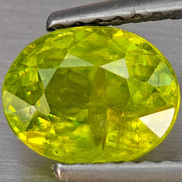 Natural Multi-Color With Rainbow Spark Sphene Gemstone 1.46 Ct. Oval Shape 7.8 x 6.2 Mm.: Product ID: 806509237 Product Name: Natural Sphene Weight: 1.46 CT. Size: 7.8 x 6.2 x 4.2 MM. Shape: Oval Shape Color: Multi-Color Clarity:SI1 Luster: Good Gems Origin: Madagascar Treatment: Unheated 