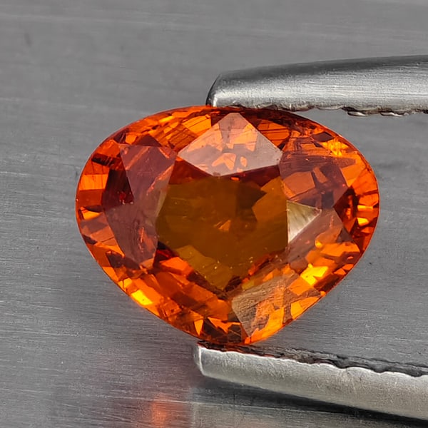 Natural Reddish Orange Spessartine Garnet Gemstones 1.08 Ct. Pear Shape 7 x 5.6 Mm.: Product ID: 802926023 Product Name: Natural Spessartine Weight: 1.08 CT. Size: 7 x 5.6 x 3.2 MM. Shape: Pear Color: Reddish Orange Clarity:SI1 Luster: Good Gems Origin: Namibia, Africa Treatment: Unhe