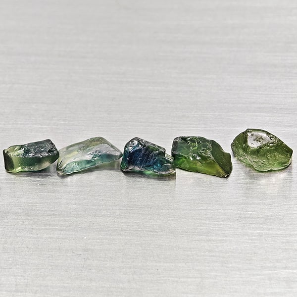 Natural Unheated Greenish Blue Sapphire Gemstones 3.82 Ct. 5 Pcs. Rough Shape Mixed Size: Product ID: 806162512 Product Name: Natural Green Sapphire Weight: 3.82 CT. Size: 6.3 x 3.3 x 2.6 to 7.2 x 4.7 x 3.3 MM. Shape: Rough Mixed Shape Color: Greenish Blue Clarity:VSI Luster: Good Gems Ori