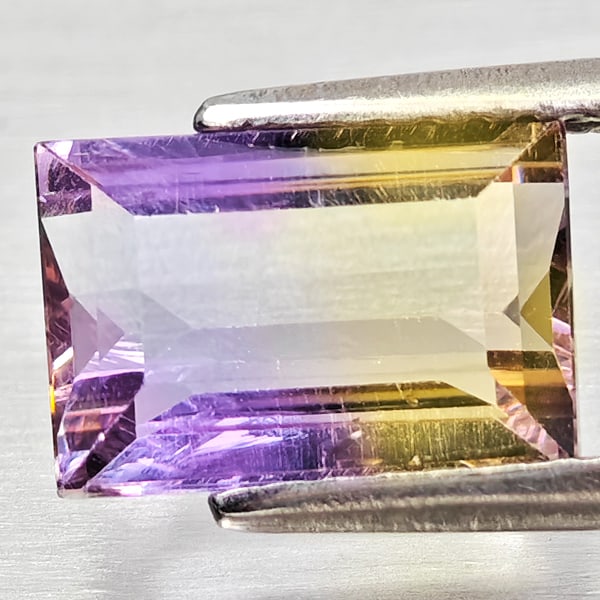 Natural Bi Color Ametrine Gemstones 2.08 Ct. Octagon Shape 9.2 x 6.3 Mm.: Product ID: 800408369 Product Name: Natural Ametrine Weight: 2.08 CT. Size: 9.2 x 6.3 x 4.4 MM. Shape: Octagon Color: Bi Color Clarity:VSI - SI1 Luster: Good Gems Origin: Bolivia Treatment: Unheated C