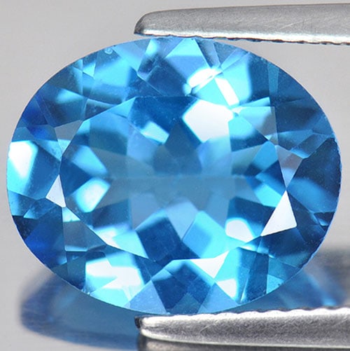 Natural Swiss Blue Topaz Gemstones 4.87 Ct. VVS Oval Shape 12 x 10 Mm.: Product ID: 807161106 Product Name: Natural Blue Topaz Weight: 4.87 CT. Size: 12 x 10 x 5.7 MM. Shape: Oval Color: Swiss Blue Clarity:VVS Luster: Good Gems Origin: Brazil Treatment: Treated Crystal St