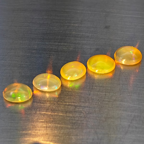 Natural Multi-Color Play Of Colour Opal Gemstones 2.91 Ct. 5 Pcs. Oval Cabochon Shape 7.2 x 5.2 Mm.: Product ID: 818728336 Product Name: Natural Opal Weight: 2.91 CT. Size: 7.2 x 5.2 x 4 to 6.5 x 5.4 x 3.5 MM. Shape: Oval Cabochon Color: Multi-Color Clarity:None Luster: Good Gems Origin: Ethiopia Tre
