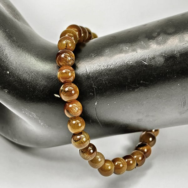 Natural Yellow Brown Color Tigers Eye Gemstones 48.15 Ct. Beads Bracelet Length 6 Inch.: Product ID: 811600316 Product Name: Natural Agate Weight: 48.15 CT. Size: 6 Inch 6.7 x 6.7 MM. Shape: Round Cabochon Color: Yellow Brown Clarity:Opaque Luster: Good Gems Origin: Thailand Treatment: Un