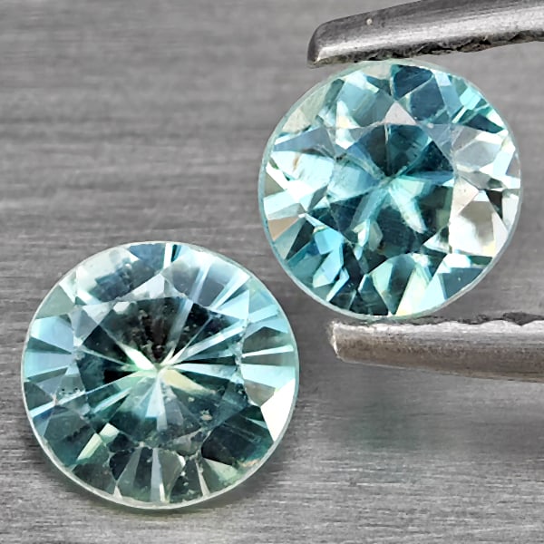 Natural Blue Zircon Gemstones 1.24 Ct. 2 Pcs Round Diamond Cut 5 Mm.: Product ID: 807743238 Product Name: Natural Zircon Weight: 1.24 CT. Size: 5 x 5 x 2.7 MM. Shape: Round Diamond Cut Color: Blue Clarity:SI1 Luster: Good Gems Origin: Cambodia Treatment: Heated Crystal 