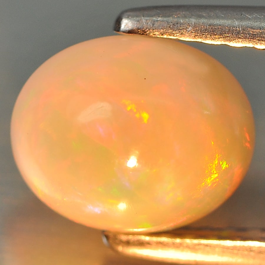 Natural Multi Color Opal Gemstones 1.52 Ct. Oval Cabochon Shape 8.5 x 7 Mm.: Product ID: 818707599 Product Name: Natural Opal Weight: 1.52 CT. Size: 8.5 x 7 x 5.2 MM. Shape: Oval Cabochon Color: Multi Color Clarity:Semi - Transparent Luster: Good Gems Origin: Ethiopia Treatmen
