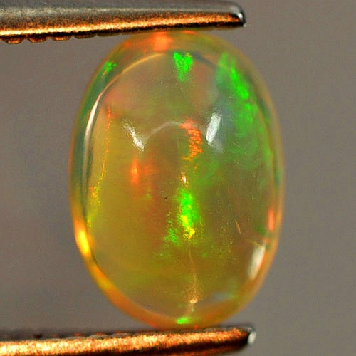 Natural Multi Color Opal Gemstones 0.82 Ct. Oval Cabochon 7.8 x 5.5 Mm.: Product ID: 818725986 Product Name: Natural Opal Weight: 0.82 CT. Size: 7.8 x 5.5 x 4.2 MM. Shape: Oval Cabochon Color: Multi Color Clarity:Opaque Luster: Iridescent Gems Origin: Ethiopia Treatment: U