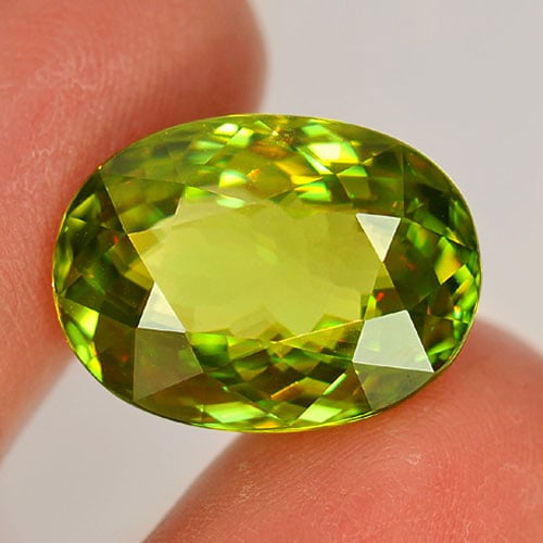 Natural Multi Color Sphene Gemstones 19.59 Ct. Clean Oval 18.4 x 13.6 Mm.: Product ID: 806507451 Product Name: Natural Sphene Weight: 19.59 CT. Size: 18.4 x 13.6 x 9.1 MM. Shape: Oval Color: Green With Rainbow Spark Clarity:IF Luster: Adamantine Gems Origin: Madagascar Treat