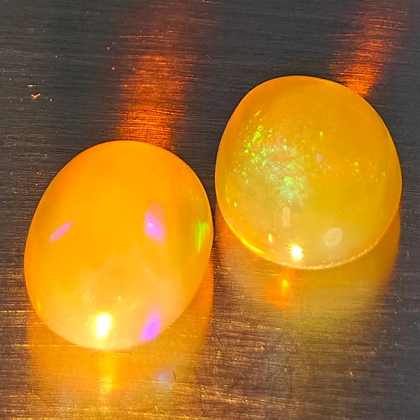 Natural Multi Color Play Of Colour Opal Gemstones 1.60 Ct. 2 Pcs. Oval Cabochon Shape: Product ID: 818728344 Product Name: Natural Opal Weight: 1.60 CT. Size: 7.7 x 5.6 x 4.4 MM. Shape: Oval Cabochon Color: Multi-Color Clarity:None Luster: Good Gems Origin: Ethiopia Treatment: Unheated 