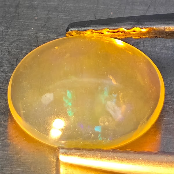Natural Multi-Color Play Of Colour Opal Gemstones 0.90 Ct. Oval Cabochon Shape 8.6 x 7 Mm.: Product ID: 818728299 Product Name: Natural Opal Weight: 0.90 CT. Size: 8.6 x 7 x 3.6 MM. Shape: Oval Cabochon Color: Multi-Color Clarity:None Luster: Good Gems Origin: Ethiopia Treatment: Unheated Cr