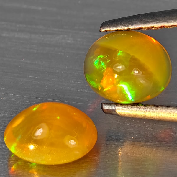 Natural Multi Color Play Of Colour Opal Gemstones 1.24 Ct. 2 Pcs Oval Cabochon Shape 7 x 5.2 Mm.: Product ID: 818728350 Product Name: Natural Opal Weight: 1.24 CT. Size: 7 x 5.2 x 4.1 MM. Shape: Oval Cabochon Color: Multi-Color Clarity:None Luster: Good Gems Origin: Ethiopia Treatment: Unheated Cr
