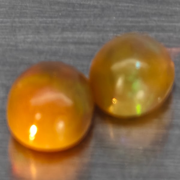 Natural Multi Color Play Of Colour Opal Gemstones 1.50 Ct. 2 Pcs Oval Cabochon Shape 6.9 x 5.5 Mm.: Product ID: 818728341 Product Name: Natural Opal Weight: 1.50 CT. Size: 6.9 x 5.5 x 4.4 MM. Shape: Oval Cabochon Color: Multi-Color Clarity:None Luster: Good Gems Origin: Ethiopia Treatment: Unheated 