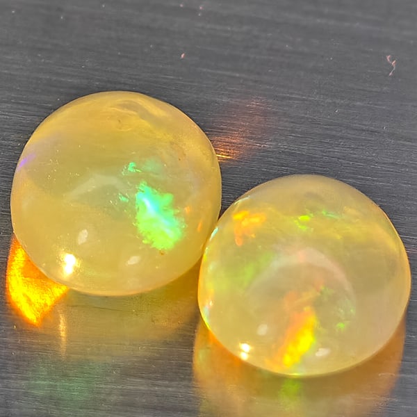 Natural Multi Color Play Of Colour Opal Gemstones 1.42 Ct. 2 Pcs Oval Cabochon Shape 7.4 x 5.7 Mm.: Product ID: 818728342 Product Name: Natural Opal Weight: 1.42 CT. Size: 7.4 x 5.7 x 4 MM. Shape: Oval Cabochon Color: Multi-Color Clarity:None Luster: Good Gems Origin: Ethiopia Treatment: Unheated Cr