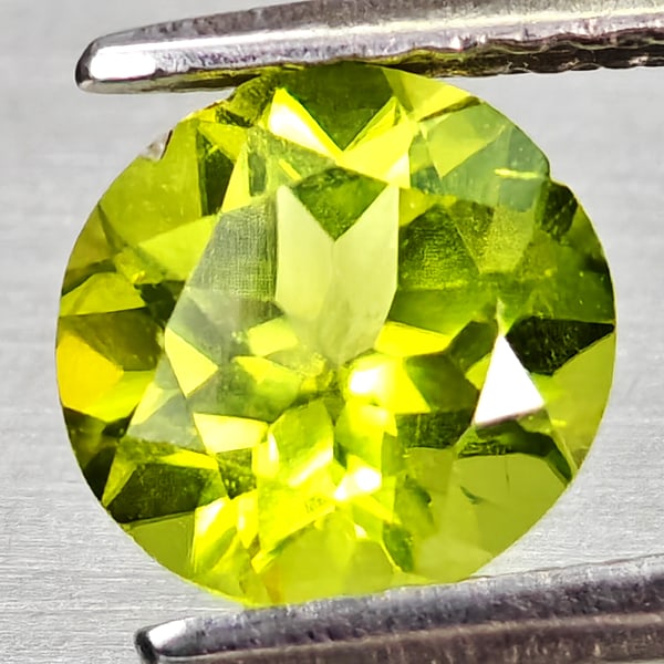 Natural Green Peridot Gemstones 1.12 Ct. Round Shape 6.7 Mm.: Product ID: 805317202 Product Name: Natural Peridot Weight: 1.12 CT. Size: 6.7 x 6.7 x 4.1 MM. Shape: Round Color: Green Clarity:VSI Luster: Good Gems Origin: Pakistan Treatment: Unheated Crystal Stru